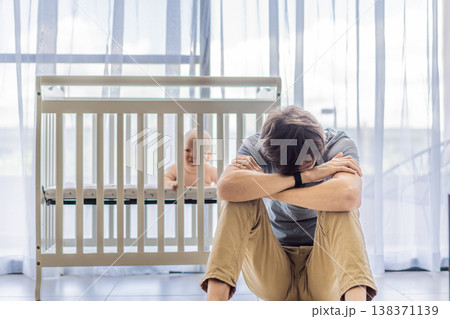 Tired father sitting by baby crib at home watching sleeping infant. Exhausted dad caring for newborn at night. Parenting fatigue, childcare responsibility, love and real family life concept Tired father sitting by baby crib at home watching sleeping infant. Exhausted dad caring for newborn at night. Parenting fatigue, childcare responsibility, love and real family life concept 138371139