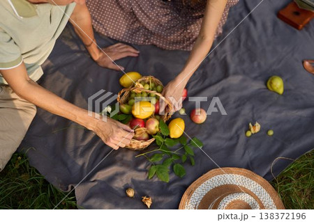 Relaxed outdoor picnic centered around colorful fresh fruits Relaxed outdoor picnic centered around colorful fresh fruits 138372196