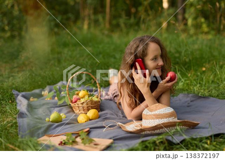 Candid image capturing woman in summer enjoying fruit as creative accessory 138372197