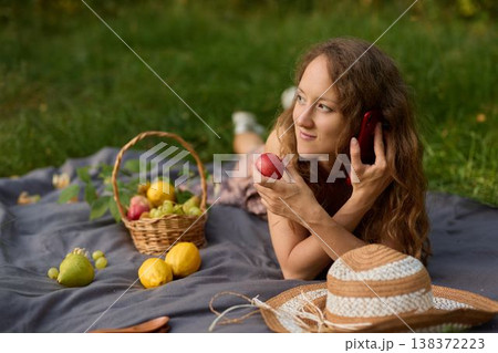 Casual scene of woman with fresh produce and sunny backdrop 138372223