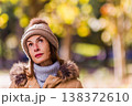 Woman with pensive expression wearing winter clothing outdoors. Eating disorder 138372610