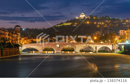 Ponte Pietra over Adige River at night in Verona, Italy 138374118
