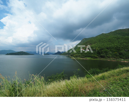 Lake mountain cloud sky water grass serene lake mountain landscape dramatic cloud sky, peaceful nature scenery with calm water 138375411