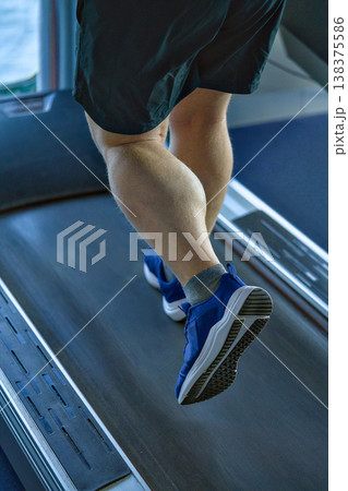 Intense Gym Session With Focused Calf Muscles Moving Rhythmically On Treadmill 138375586