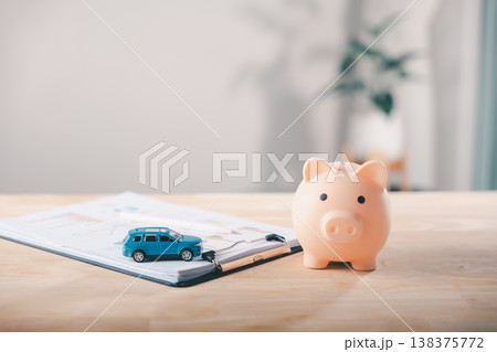 Car piggy bank money insurance contract finance auto lease price save documents with savings represents car loan management plus personal financial investment planning on table 138375772