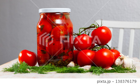 Pickled tomatoes in glass jar 138376179