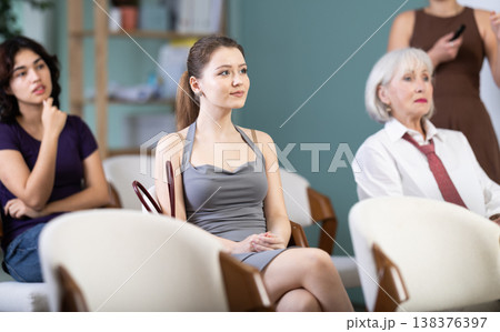 Female students are sitting in study room. Coach speaker telling in background. Female students are sitting in study room. Coach speaker telling in background. 138376397