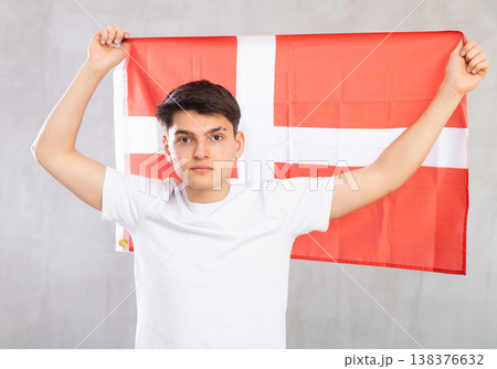 Guy holding the Danish flag in her hands Guy holding the Danish flag in her hands 138376632