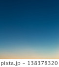 Photo of a beautiful clear evening sky without clouds. Sky gradient from orange to blue. 138378320