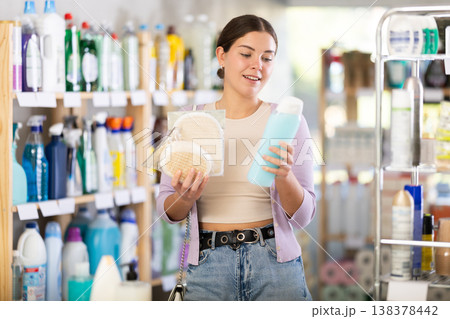Pretty young woman with gel buying body washcloth in store 138378442