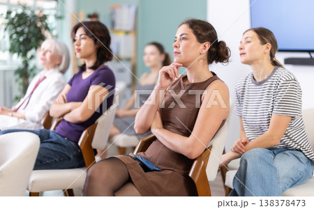 Group of women sitting on chairs and listening to presentation Group of women sitting on chairs and listening to presentation 138378473