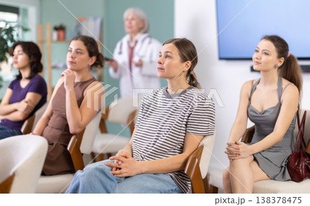 Female students are sitting in study room. Doctor speaker telling in background. Female students are sitting in study room. Doctor speaker telling in background. 138378475
