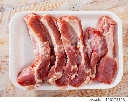 Cut raw pork ribs in plastic tray Cut raw pork ribs in plastic tray 138378568