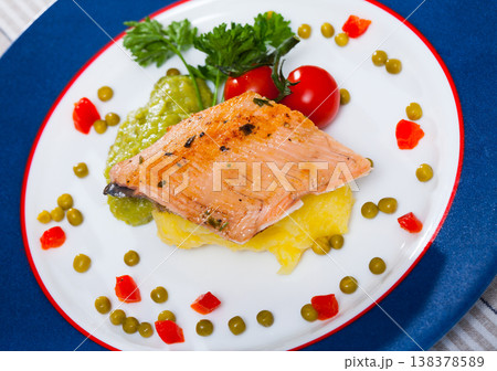 Tasty fried trout fillet with mashed potatoes, guacamole, tomatoes and greens Tasty fried trout fillet with mashed potatoes, guacamole, tomatoes and greens 138378589