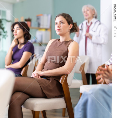 Young woman watching presentation with medical professor in the background 138378598