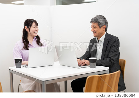 パーテーションのあるスペースでパソコン作業をする会社員の男女 パーテーションのあるスペースでパソコン作業をする会社員の男女 138380084