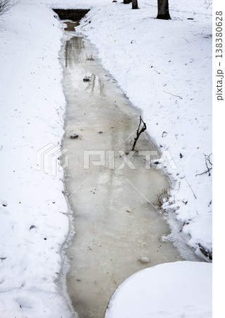 Frozen Water Channel Leading To Culvert In Snowy Winter Landscape 138380628
