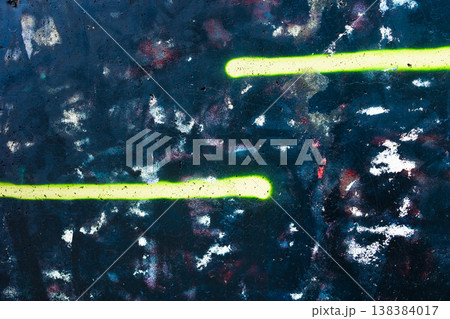 Graffiti on Blue Concrete Wall with Neon Yellow Spray Paint Lines 138384017
