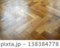 Close-up view of a classic oak parquet floor laid in a herringbone pattern 138384778