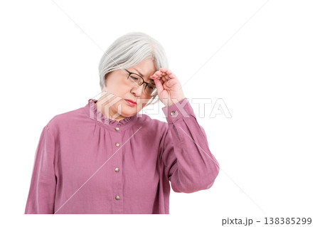 頭痛,体調不良で頭を押さえるグレイヘアのシニア女性 138385299