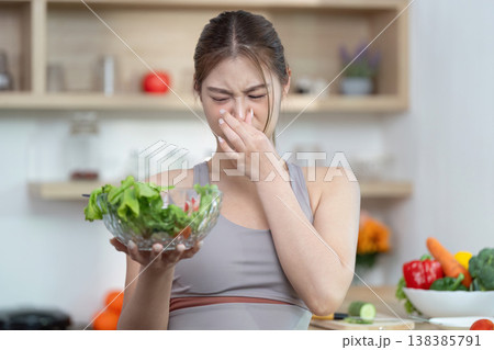 Woman reacting to unpleasant smell from a salad 138385791