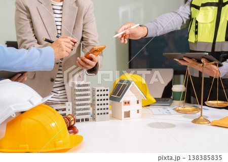 Concept of construction law, real estate development, renewable energy housing, and engineering collaboration. Concept of construction law, real estate development, renewable energy housing, and engineering collaboration. 138385835