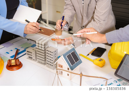 Concept of construction law, real estate development, renewable energy housing, and engineering collaboration. Concept of construction law, real estate development, renewable energy housing, and engineering collaboration. 138385836