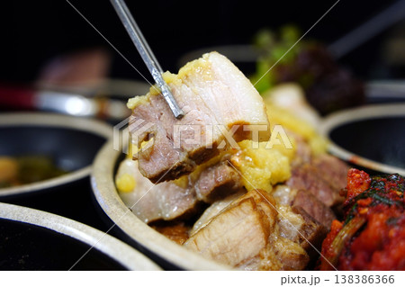 Korean Boiled Pork Belly (Bossam) with Garlic Topping and Kimchi 138386366