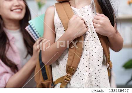 Close-up of girl with backpack during back-to-school preparation Close-up of girl with backpack during back-to-school preparation 138386497
