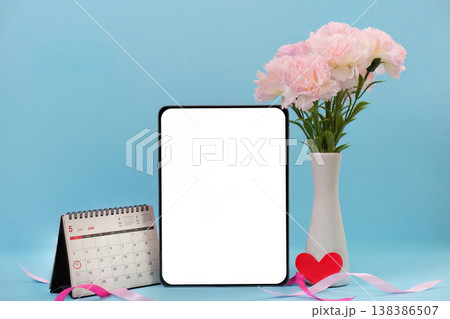 Mother's Day calendar and floral arrangement with tablet 138386507