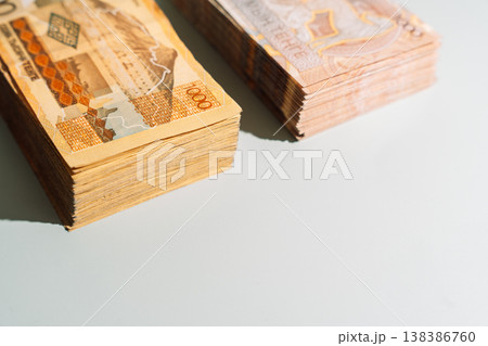 Two stacks of 1000 Kazakhstani tenge banknotes with different designs on green background, finance concept with copy space Two stacks of 1000 Kazakhstani tenge banknotes with different designs on green background, finance concept with copy space 138386760