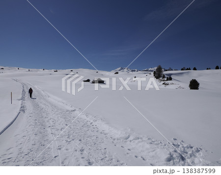 trekker near wooden hut covered by snow in armentarola pralongia dolomites mountains trekker near wooden hut covered by snow in armentarola pralongia dolomites mountains 138387599