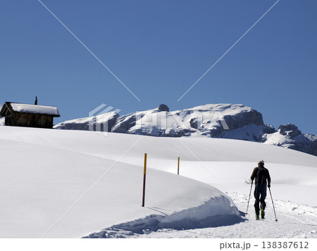trekker near wooden hut covered by snow in armentarola pralongi? dolomites mountains 138387612