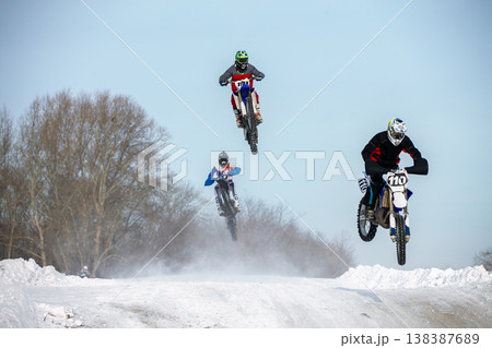 Three motocross riders jump Three motocross riders jump 138387689
