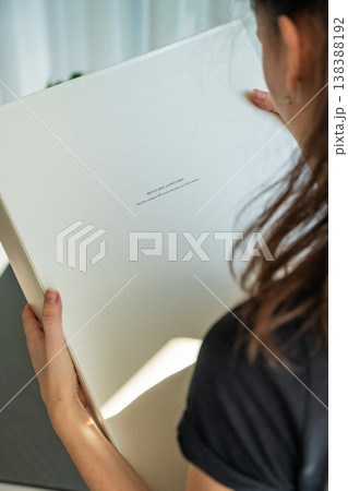Person holding eco friendly package made from recycled materials with sustainability label. Reusable and environmentally conscious packaging concept. Person holding eco friendly package made from recycled materials with sustainability label. Reusable and environmentally conscious packaging concept. 138388192