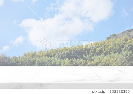 Marble Table with lush green forest on a hillside and cloudy blue sky Marble Table with lush green forest on a hillside and cloudy blue sky 138388390