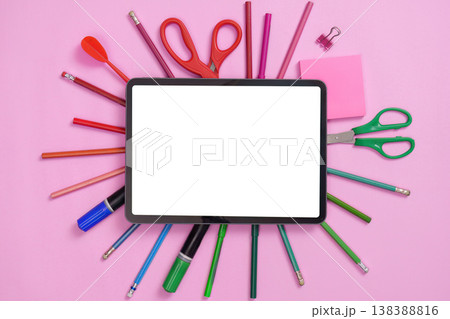 Tablet with school supplies on pink background 138388816