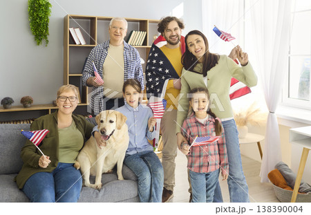 Smiling family with grandparents waving American flags home, celebrating freedom Smiling family with grandparents waving American flags home, celebrating freedom 138390004