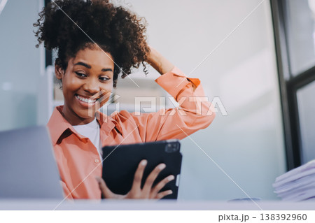 Smiling businesswoman working on laptop in office Smiling businesswoman working on laptop in office 138392960