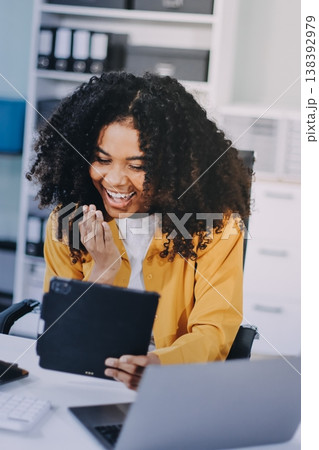 Pretty female freelancer working on laptop while sitting on modern coworking background 138392979
