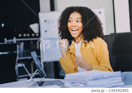 Pretty female freelancer working on laptop while sitting on modern coworking background 138392985