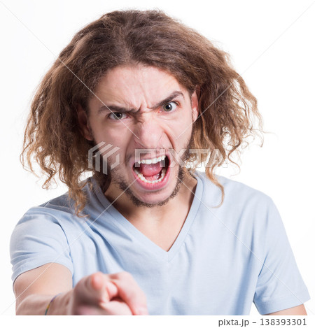 Feeling angry. Furious man shouting loud while staring direct to camera on white isolated studio background Feeling angry. Furious man shouting loud while staring direct to camera on white isolated studio background 138393301