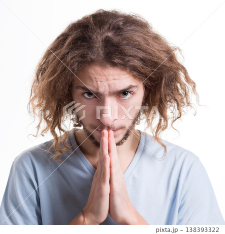 Facial expression and emotions. Hopeful man praying, holding hands clasped near face on white isolated studio background 138393322
