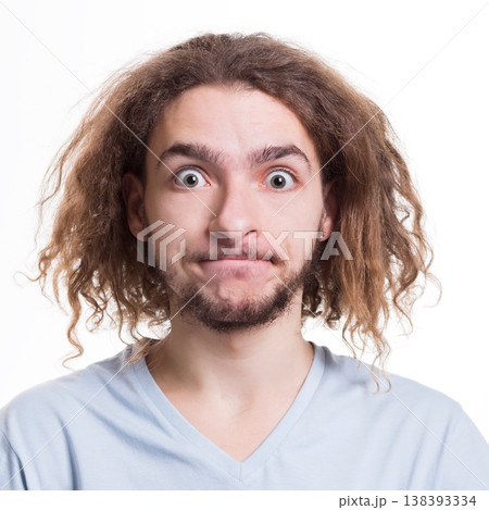 Portrait of man with surprised facial expression looking at camera while standing on white isolated studio background 138393334