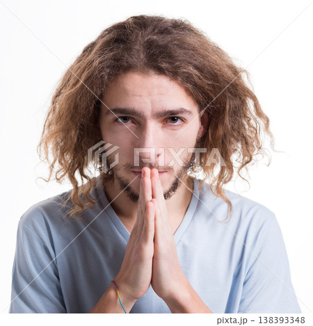 Facial expression and emotions. Begging man praying, holding hands clasped near face on white isolated studio background Facial expression and emotions. Begging man praying, holding hands clasped near face on white isolated studio background 138393348