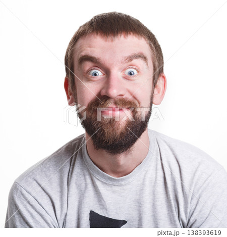 Pleasant news. Excited man expressing shock on face, smiling on white isolated studio background, portrait 138393619