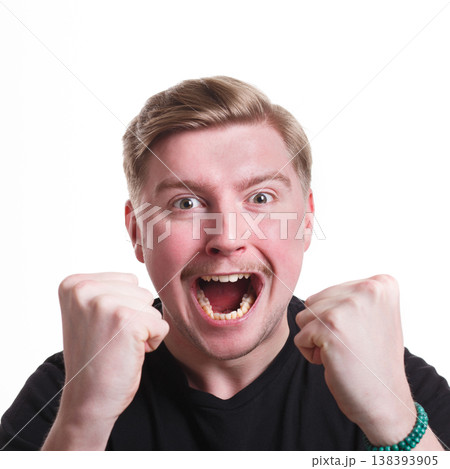 Winner celebrates. Great success. Excited man with happy facial expression shout on white isolated studio background 138393905
