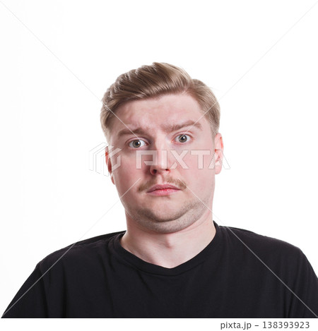 Feeling unpleasant surprised. Caucasian man grimacing to camera on white isolated background, studio shot, portrait Feeling unpleasant surprised. Caucasian man grimacing to camera on white isolated background, studio shot, portrait 138393923