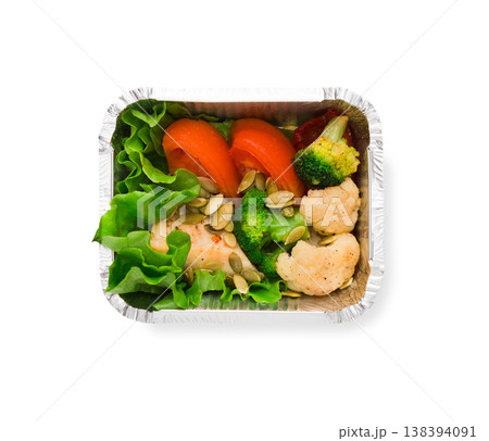 Healthy food restaurant delivery and diet concept. Take away meal in foil box. Vegetable salad with chicken 138394091