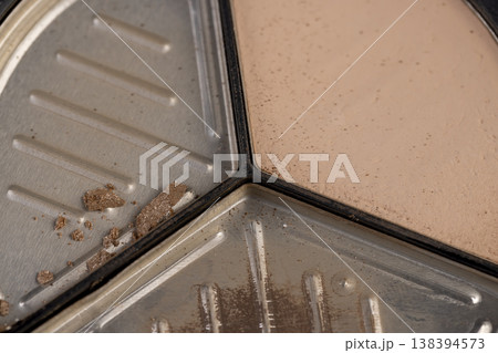 old scattered broken cosmetics, makeup powder , dust and small and large pieces of women's cosmetics that were broken and ruined 138394573